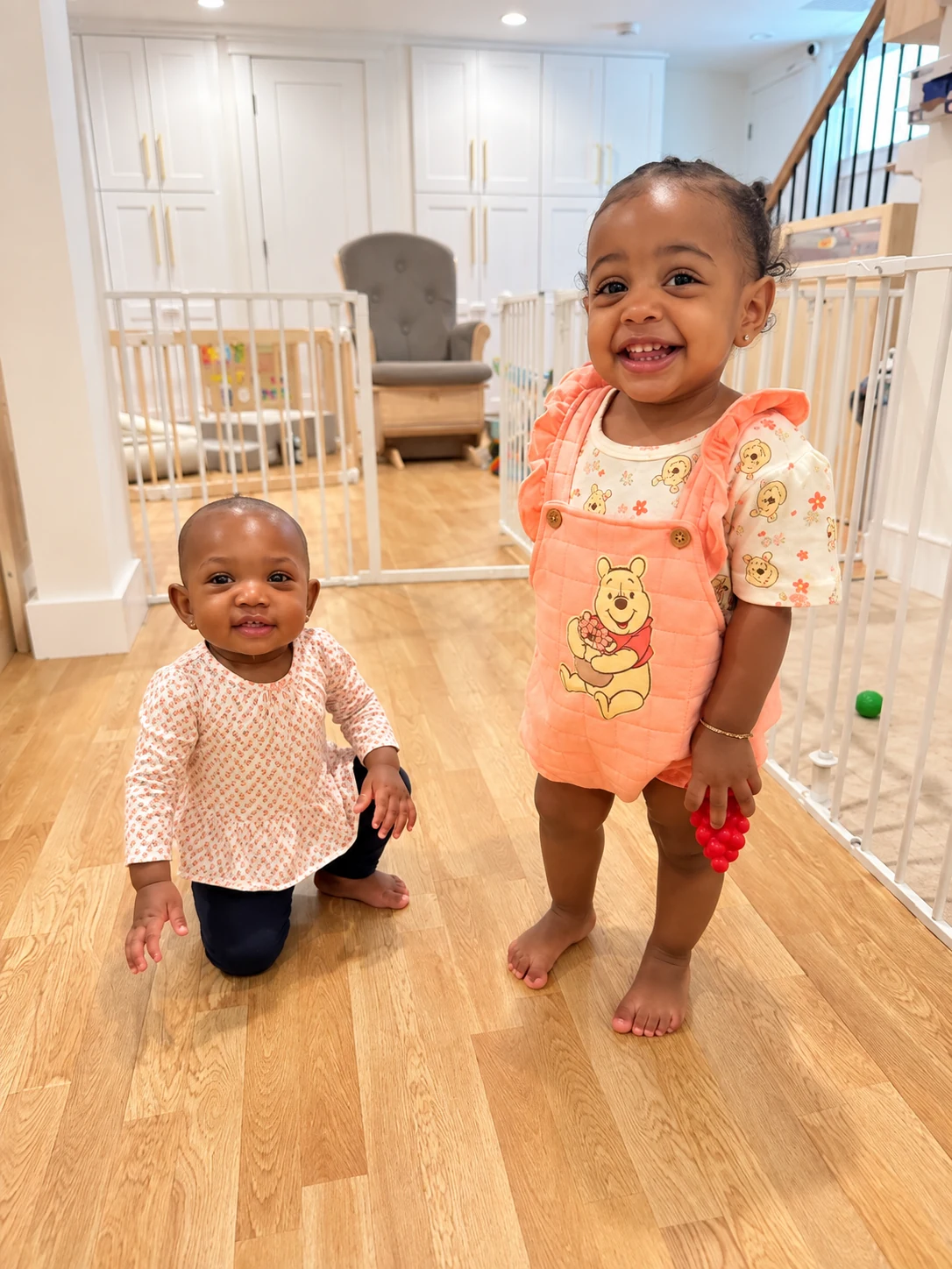 Two young children playing together in the warm, safe indoor space at Tina's Tiny Clubhouse